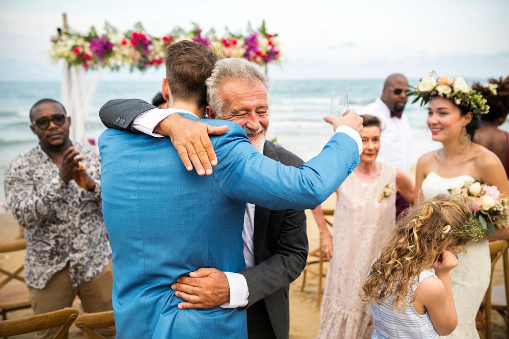 Groom hugging his dad at the wedding