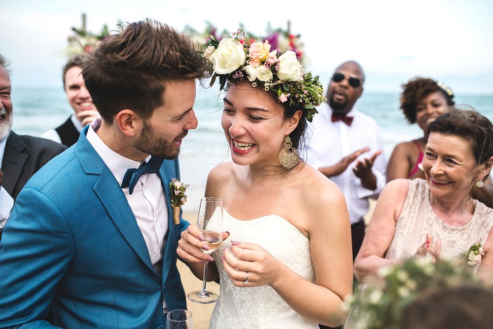 Newly weds with their guests at their beach wedding