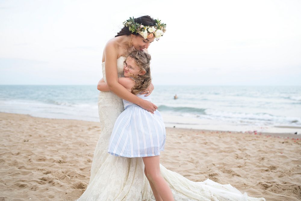 Beautiful bride and sister by the sea