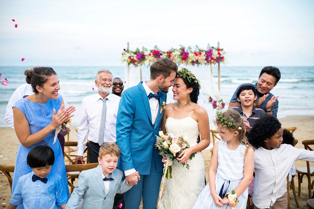 Newly weds with their guests at their beach wedding