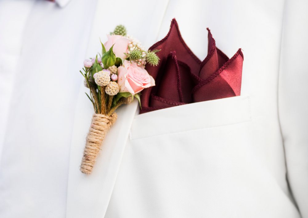Closeup of groom boutonni&egrave;re on suit lapel