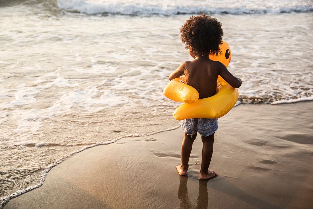 African little boy playing at the beach