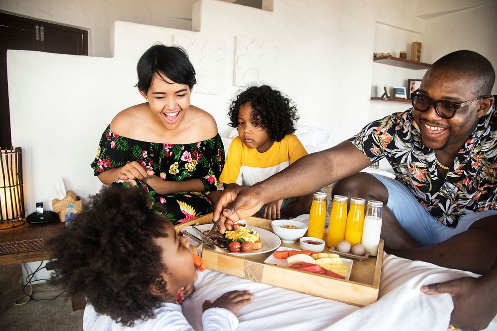 African family having breakfast in bed