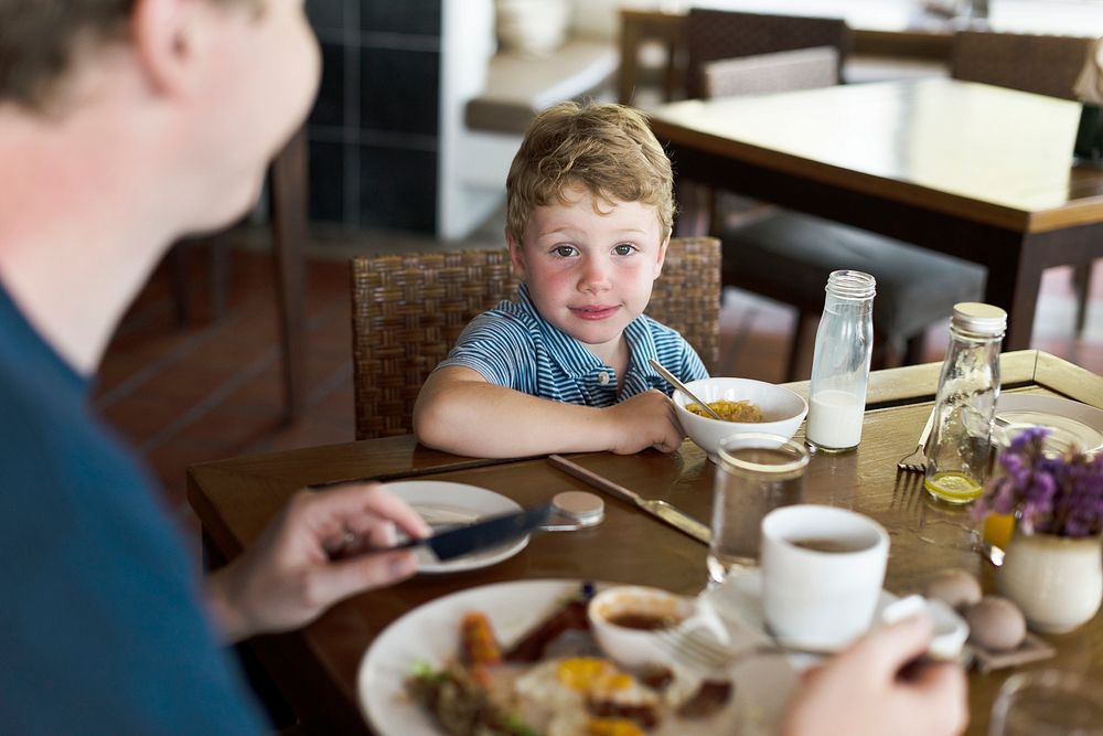 Little boy enjoying eating breakfast