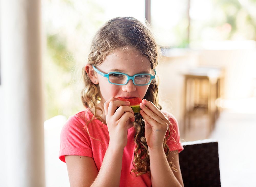Little girl enjoying eating watermelon