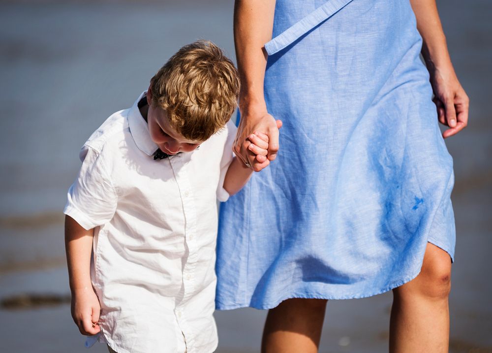 Mom and son walking on the beach