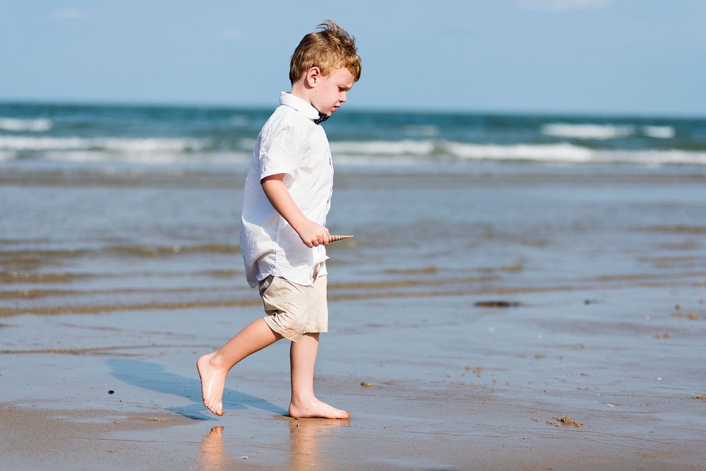 Little boy walking at the beach