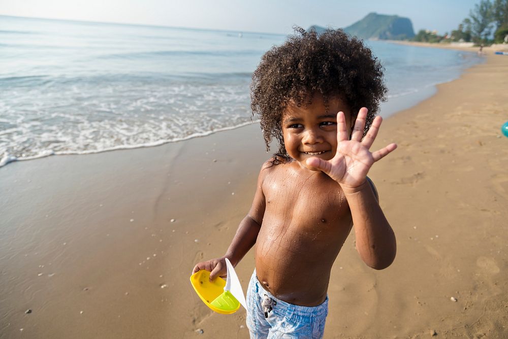 African little boy playing at the beach