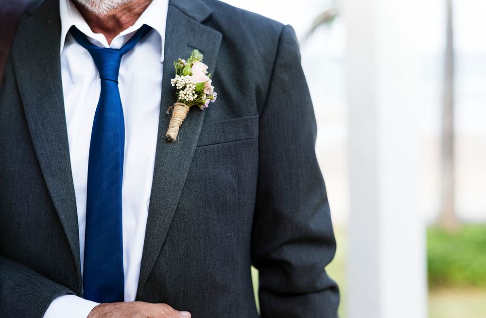 Closeup of groom boutonni&egrave;re on suit lapel