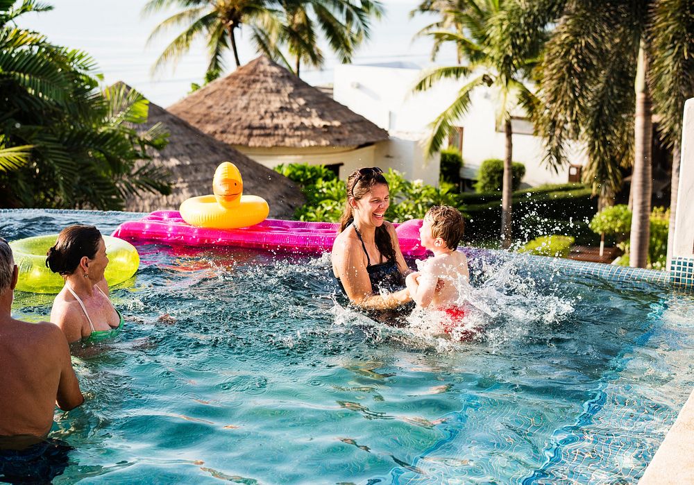 Family playing in a pool