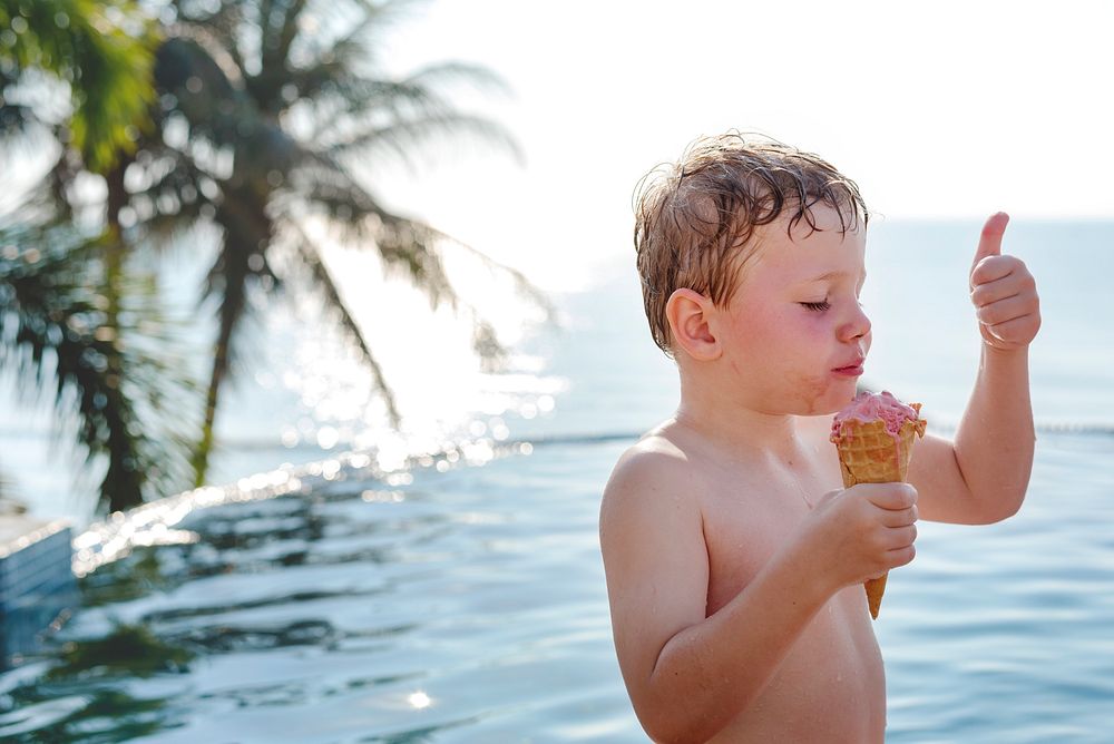 A boy and good ice cream by the pool