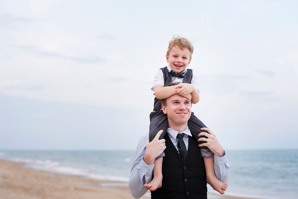 Father and son at a beach wedding