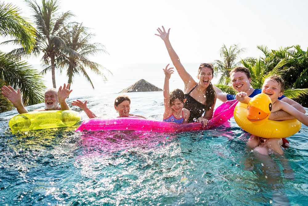 Cheerful family enjoying the summertime in a pool