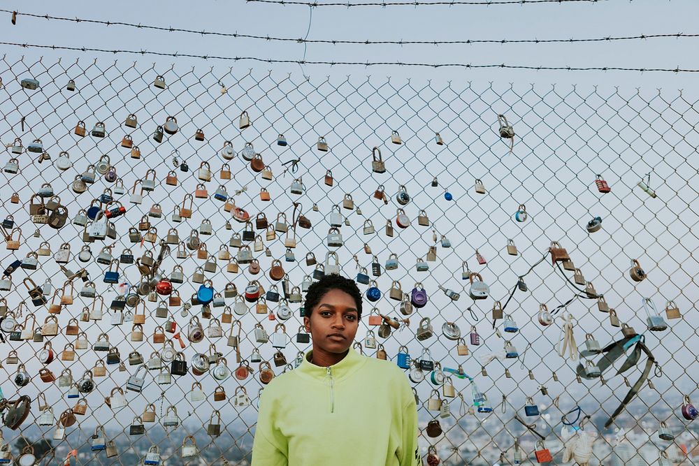 Woman by a fence with padlocks in LA
