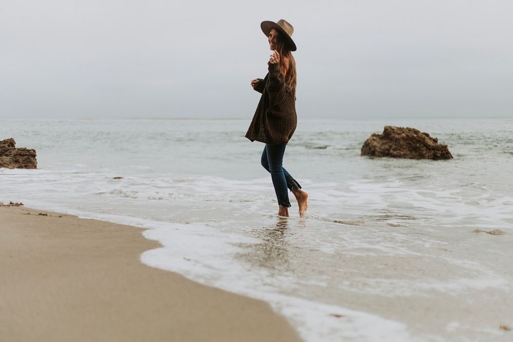 Woman walking barefoot at the beach
