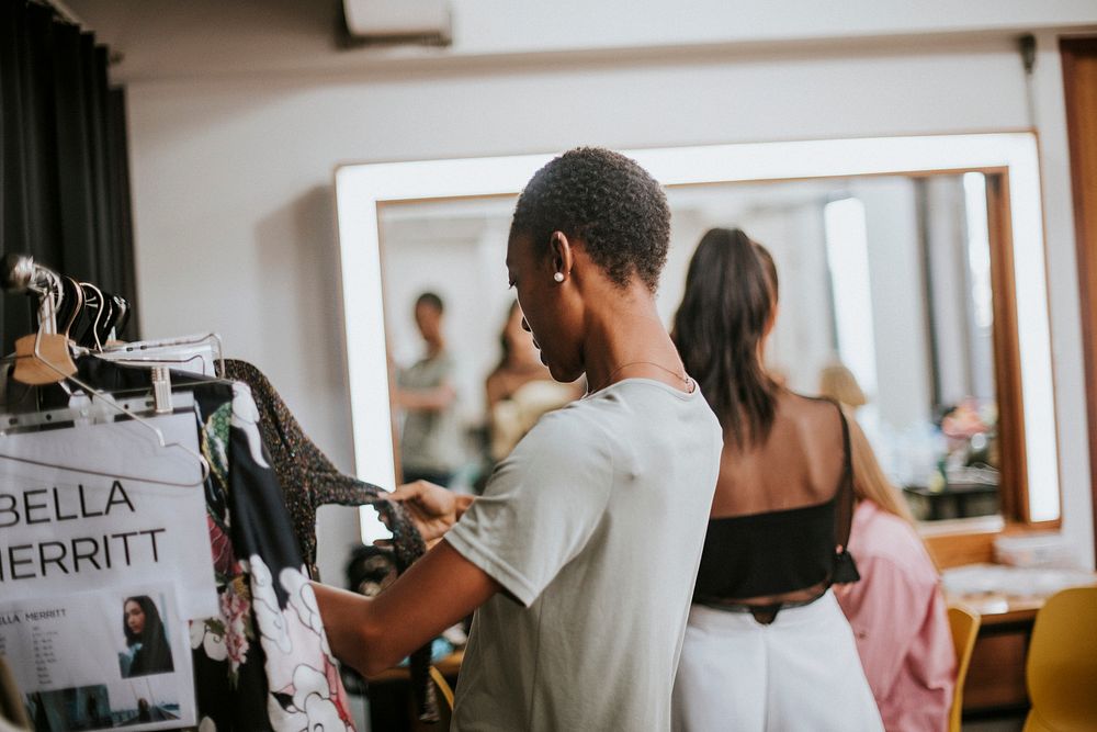 Stylist selecting clothes for a model