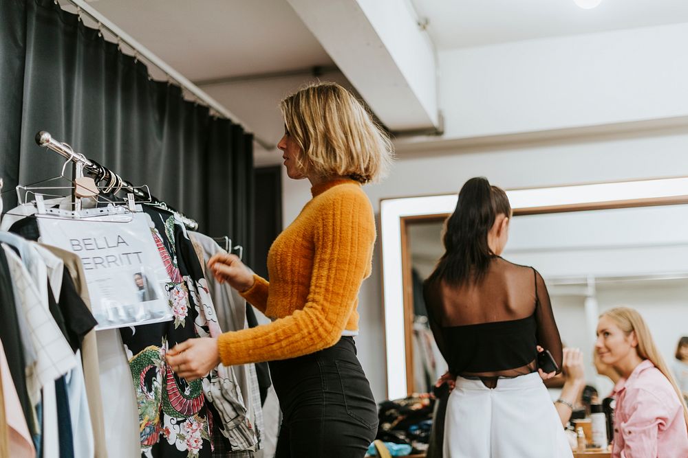Stylist selecting clothes for a model