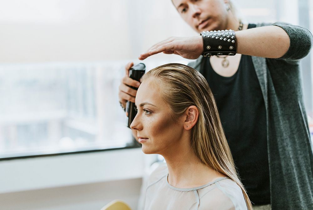 Model getting her hair done by a stylist