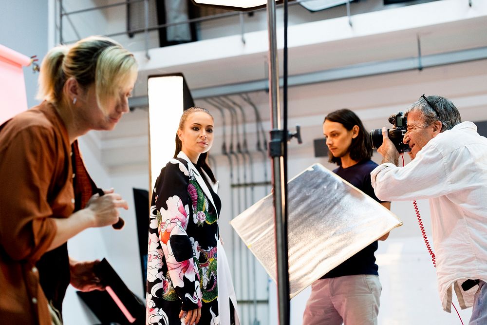 Production crew working with a model in the studio