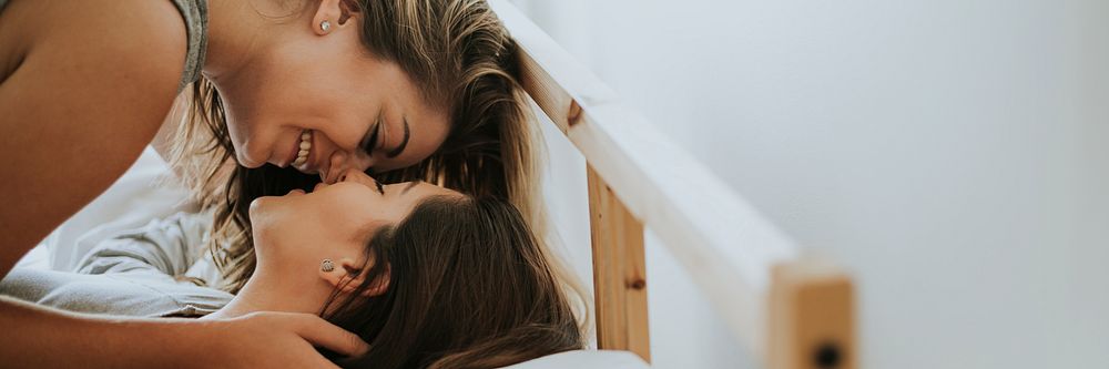 Lesbian couple kissing in the morning