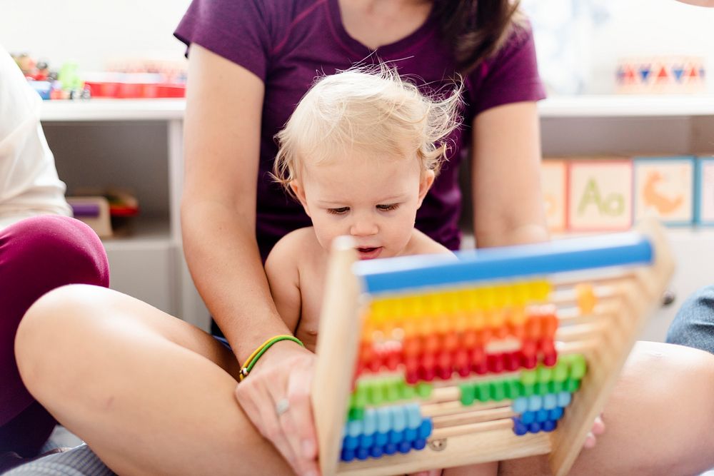 Baby playing with an abacus toy