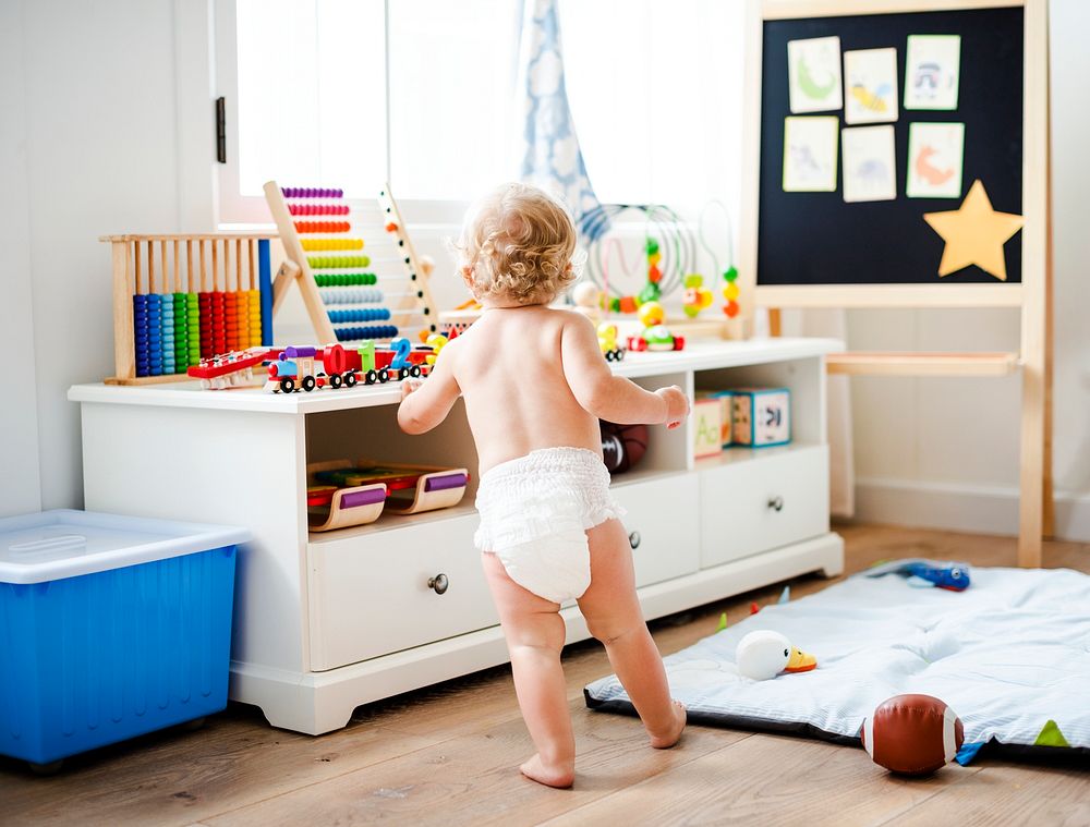 Baby in a diaper in a play room