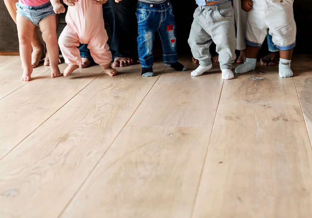 Babies walking on a wooden floor