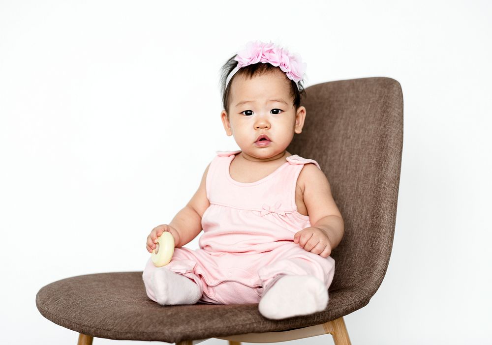 Cute baby girl sitting on a chair