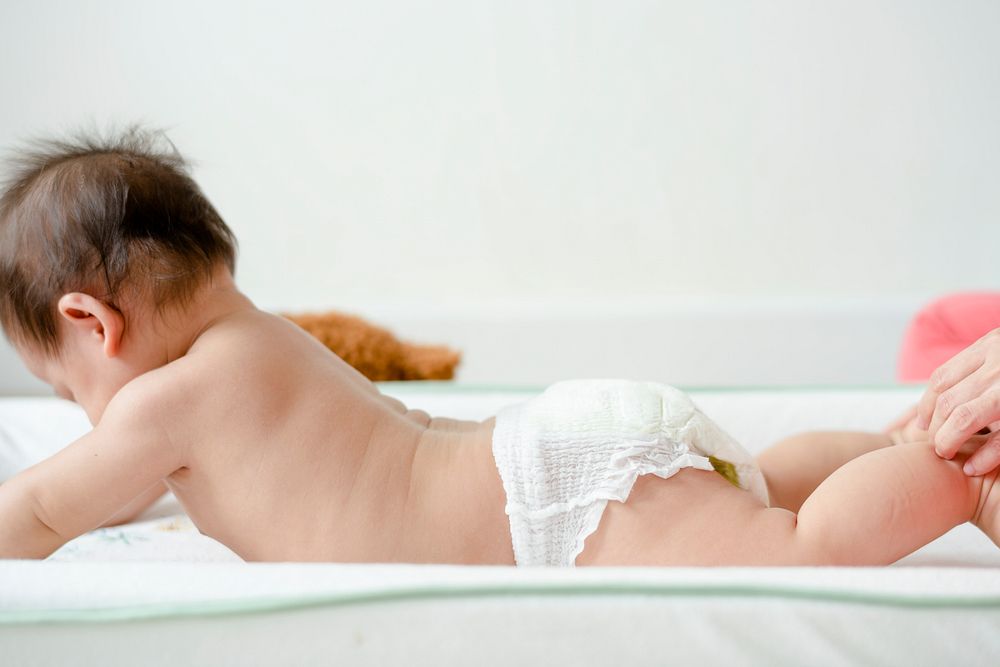 Baby in a diaper lying on her belly