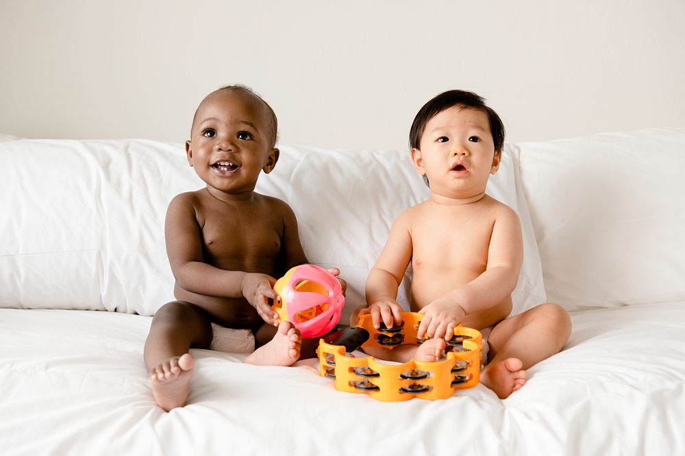 Babies playing on the bed