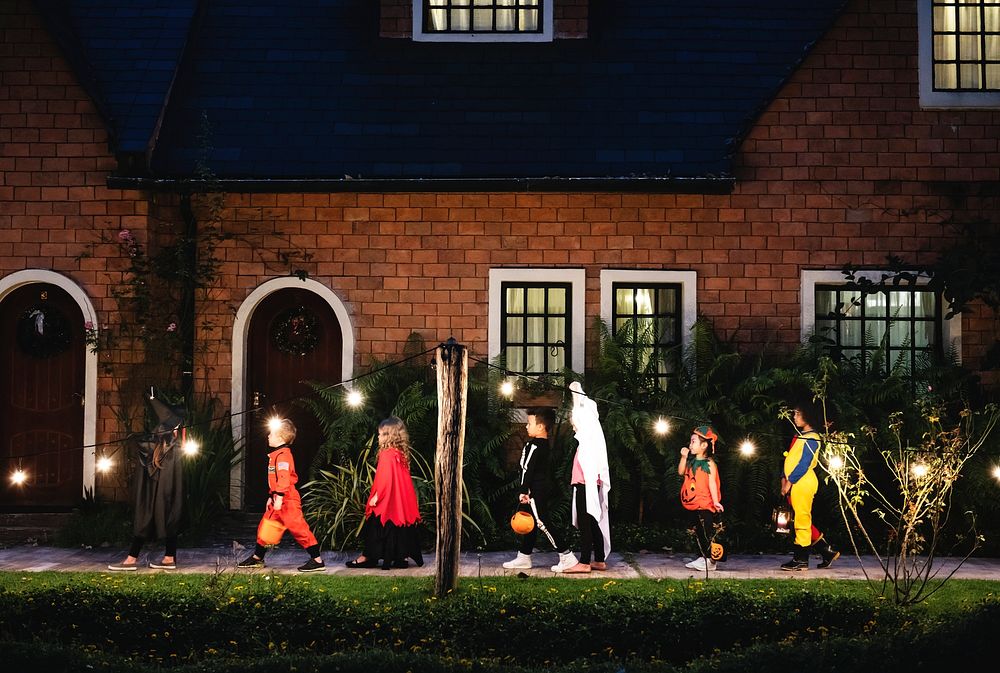 Group of kids with Halloween costumes walking to trick or treating
