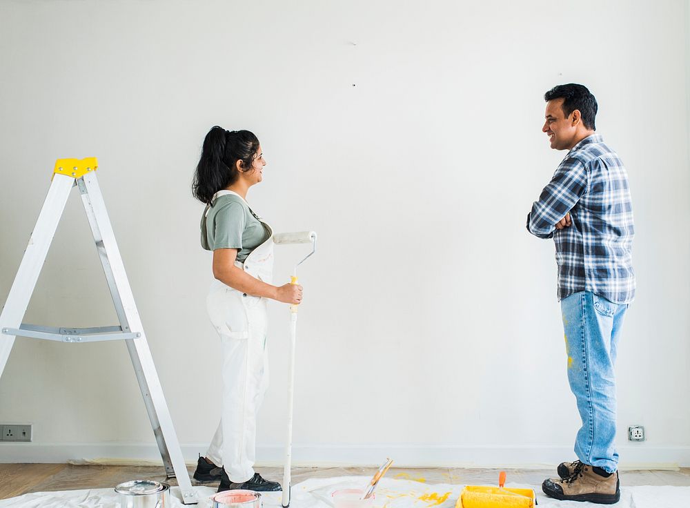 Couple painting the walls in their new apartment