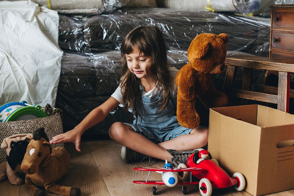 Young girl packing her toys