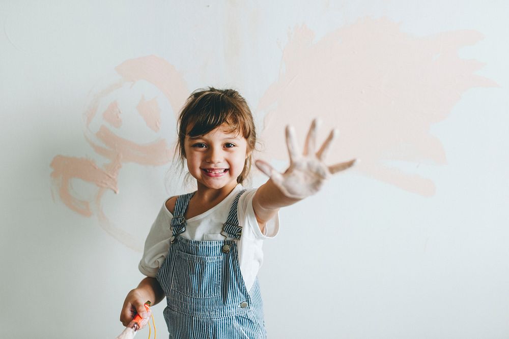 Cheerful girl showing her painted hand