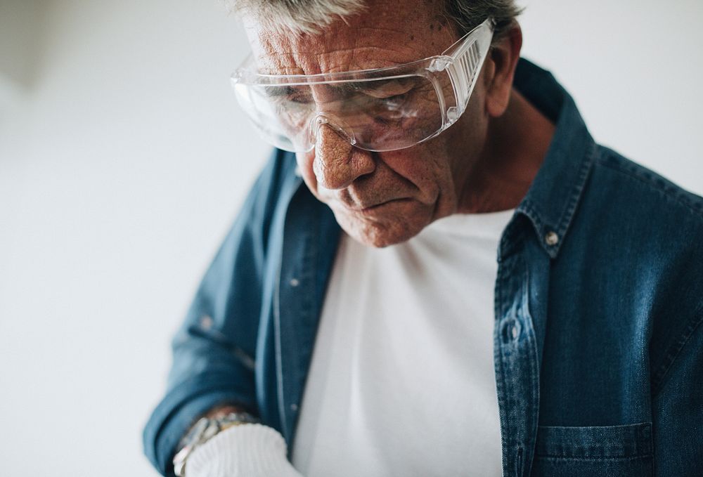 Man wearing safety glasses while renovating the house