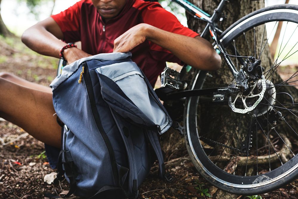 Cyclist getting stuff from backpack