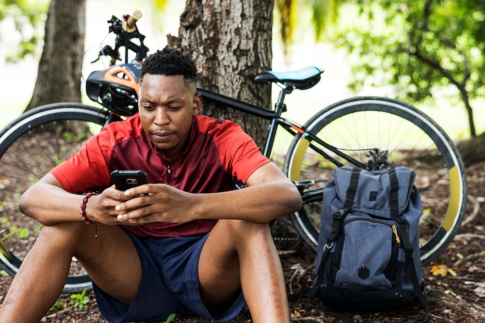 Cyclist on his phone taking a break