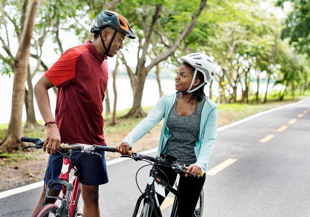 Cyclist couple talking together on bikes
