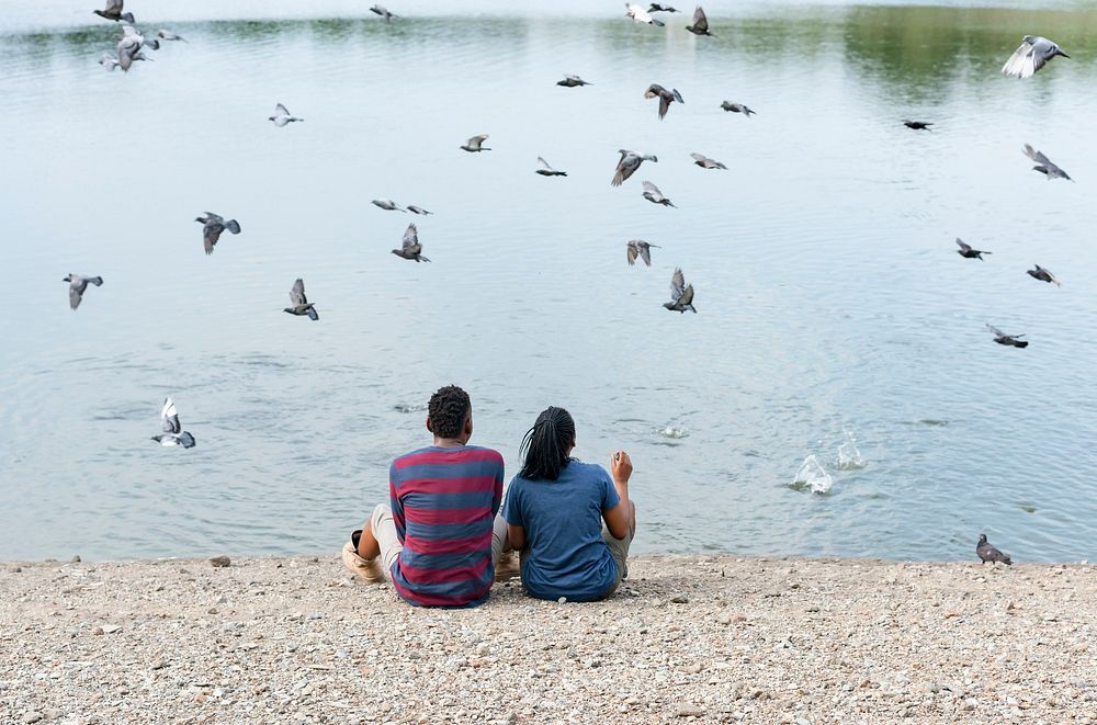 Couple sitting by the lake
