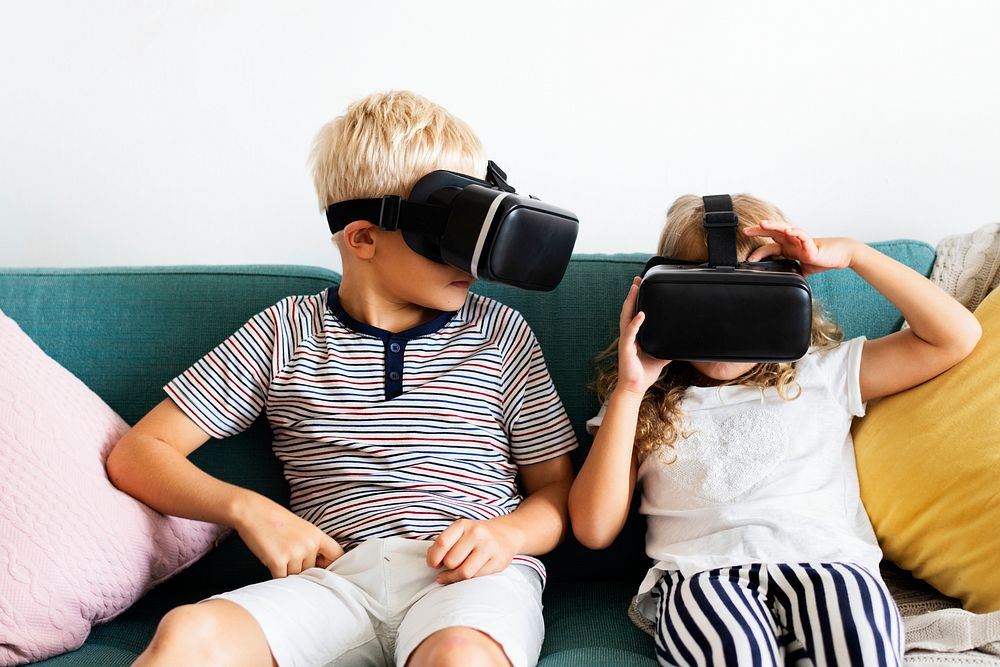 Little kids watching movies on their VR goggles