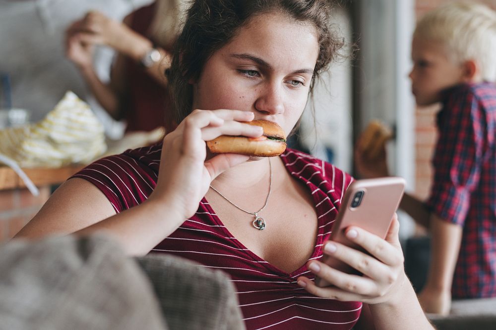 Teen girl having a takeaway burger