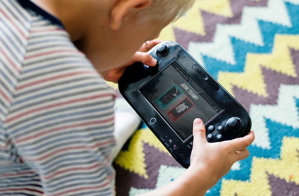 Young boy playing a portable video game