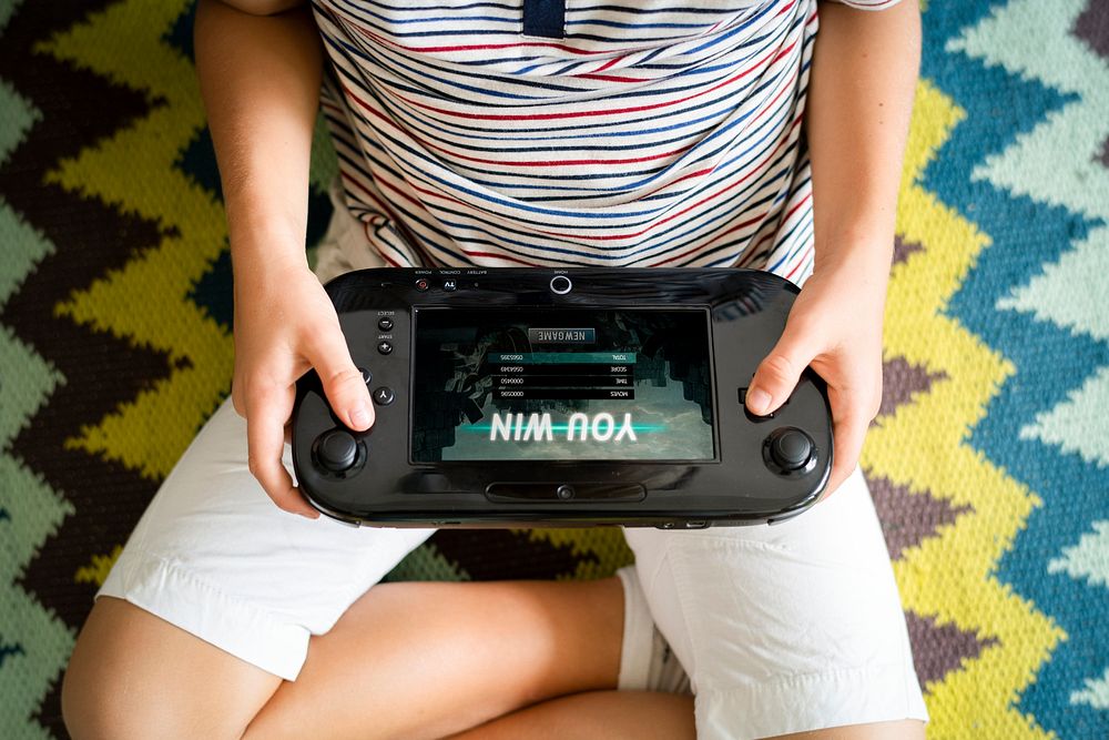 Young boy playing a portable video game
