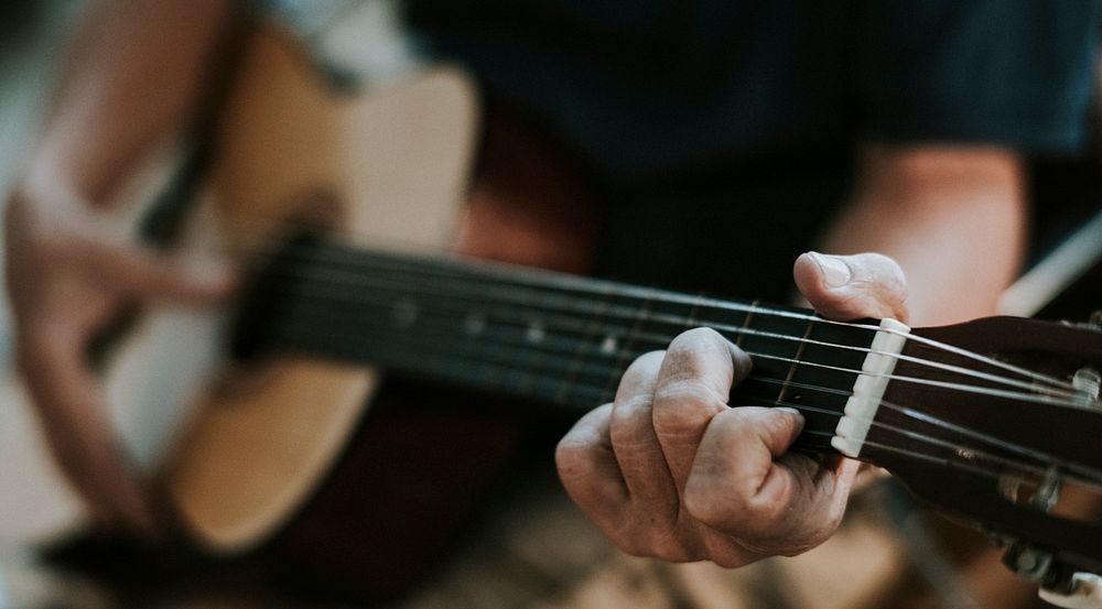 Senior man playing on his guitar