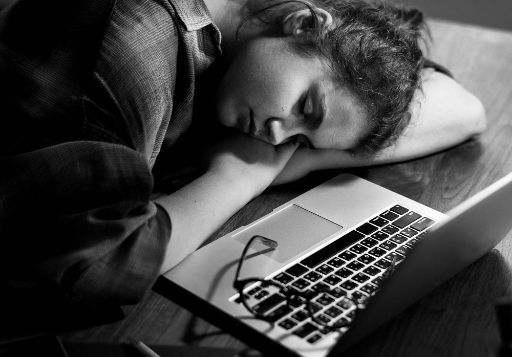 Teen girl asleep by her laptop