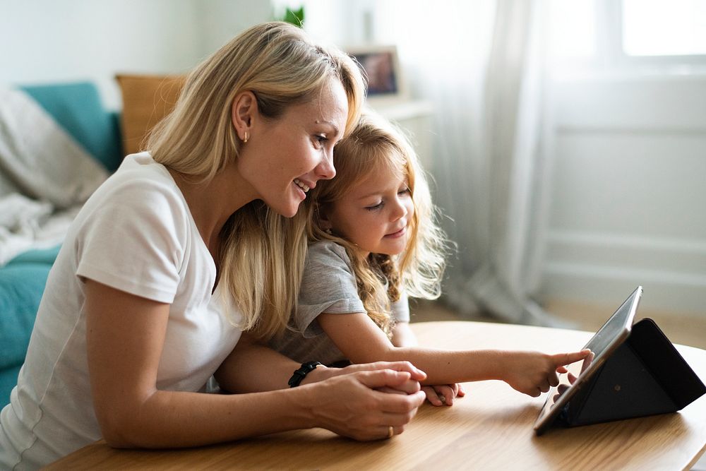 Mom and daughter watching a cartoon on a digital tablet