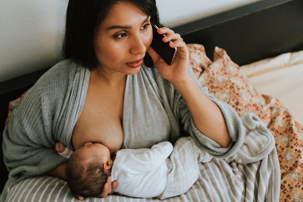 Mother breastfeeding while on the phone