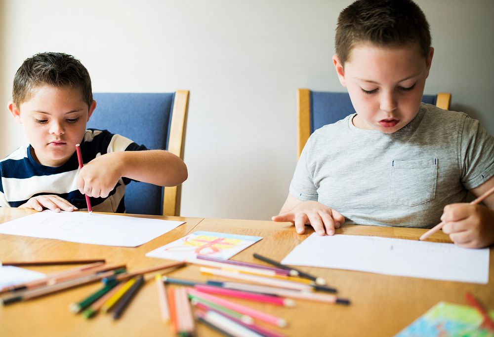 Cute brothers drawing at a table