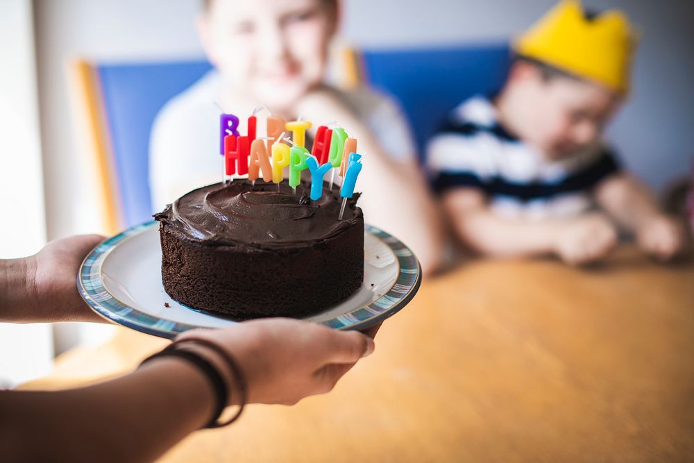 Father bringing the birthday cake