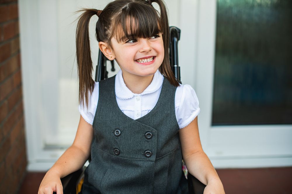 Portrait of a cute girl in a wheelchair